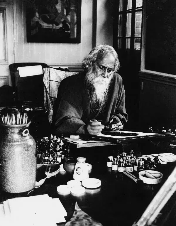 Rabindranath Tagore bent over his work at his desk, 1932